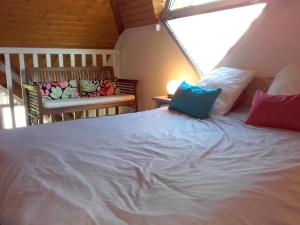 a bedroom with a white bed and two chairs at Moudang 11 in Saint-Lary-Soulan