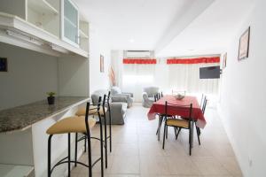 a kitchen and living room with a table and chairs at RondPoint Pilar in Pilar
