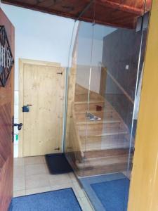 a room with a glass door and a stairway with a wooden door at Ferienhaus Bauer Wohnung 2 in Trattenbach