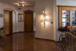 a living room with a hallway with a chandelier at Hotel Rosenhof in Ruhpolding