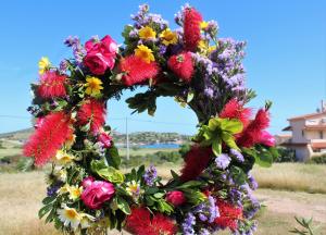 a wreath filled with flowers on a field at Helen's Sounio Apartments in Sounio