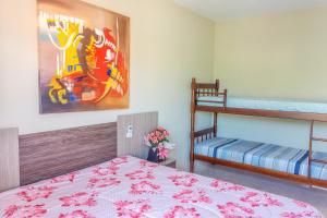 a bedroom with a bed and a bunk bed at Apto2 COM AR COND WI-FI E TV SMART in Itapema