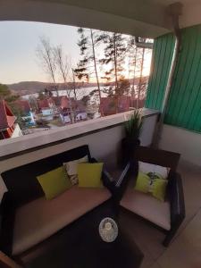 a balcony with a couch and a view of the ocean at Riviéra Lipno 510/17 in Lipno nad Vltavou