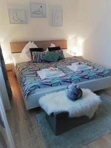 a bedroom with a large bed with a blue comforter at Riviéra Lipno 510/17 in Lipno nad Vltavou