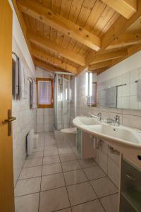 a bathroom with two sinks and a shower at Panorama Hotel & Restaurant in Bettmeralp