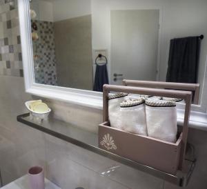 a bathroom with a shelf with three pairs of boots at Olive House in Malia +20 photos