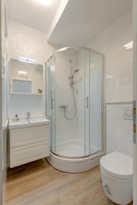 a bathroom with a shower and a toilet and a sink at CAPITAL Apartments and Rooms in Split