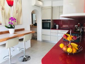 a kitchen with a bowl of fruit on a table at Villa Sunkiss Algarve Carvoeiro in Carvoeiro