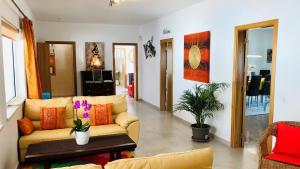 a living room with a couch and a table at Villa Sunkiss Algarve Carvoeiro in Carvoeiro