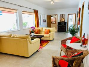 a living room with two couches and a table at Villa Sunkiss Algarve Carvoeiro in Carvoeiro