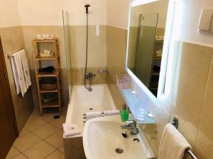 a bathroom with a tub and a sink and a shower at Villa Sunkiss Algarve Carvoeiro in Carvoeiro +37 photos