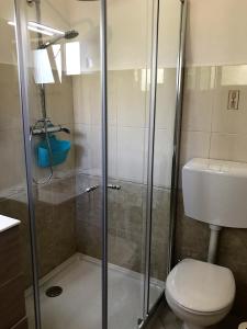 a bathroom with a shower and a toilet at Villa Sunkiss Algarve Carvoeiro in Carvoeiro