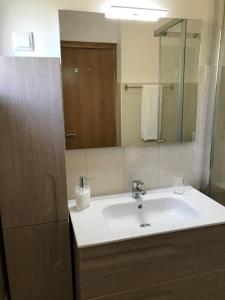 a bathroom with a sink and a mirror at Villa Sunkiss Algarve Carvoeiro in Carvoeiro