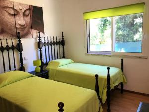 a room with two beds and a window at Villa Sunkiss Algarve Carvoeiro in Carvoeiro