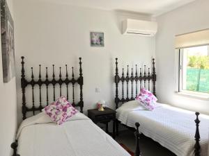 two beds sitting next to each other in a room at Villa Sunkiss Algarve Carvoeiro in Carvoeiro