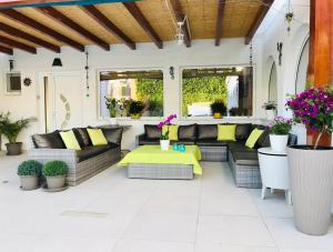 an outdoor patio with couches and a table at Villa Sunkiss Algarve Carvoeiro in Carvoeiro