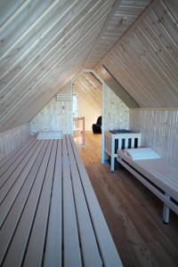 a attic room with two beds and a table at Pension Zum grünen Kakadu in Göhren