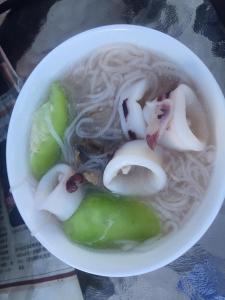 a bowl of soup with noodles and onions on a table at Penghu Color FIsh Homestay in Huxi