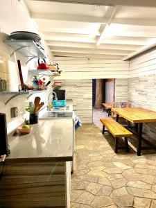 a kitchen with a counter and a table and a bench at The Beach Waikiki Boutique Hostel in Honolulu