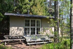 a small house with a picnic table and a bench at Sattmark EcoCabin in Pargas