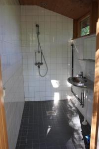 a bathroom with a shower and a sink at Sattmark EcoCabin in Pargas