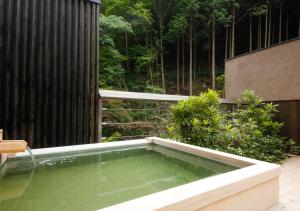 a swimming pool in the middle of a garden at Asan Kotonami in Manno