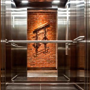 a kitchen with a brick wall and a metal appliance at Metropolitan Boutique Hotel in Krakow