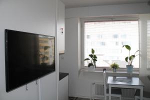 a living room with a flat screen tv on a wall at Valtakatu 2 in Pori