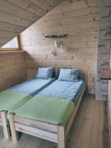 Posteľ alebo postele v izbe v ubytovaní Domek w Borowikowym Zaciszu