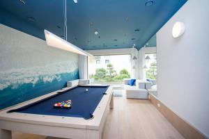 a pool table in a room with blue ceilings at Yellow Rentyear Apartments in Gdańsk