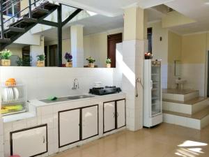 a large kitchen with a sink and a stove at Indekost Bogor in Bogor