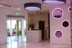 a lobby with a pink wall with a counter at Petsas Apartments in Coral Bay