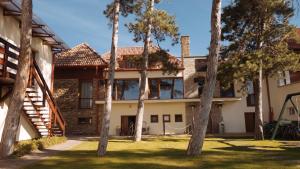 an exterior view of a house with trees at Royal Mediterran in Siófok