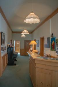 a large room with a desk and chairs and lights at Pension Haus Marga in Wernigerode