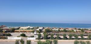 an aerial view of a town with the ocean at Hotel Corallo in Fregene