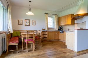 a kitchen with a table and a dining room at Haus Stangl in Bad Aussee