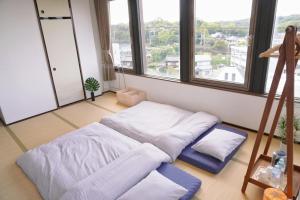 Japanese House Osaka Sennan Hotel（大阪泉南酒店和築）にあるベッド