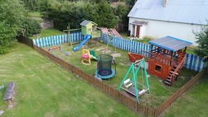a backyard with a playground with a play equipment at Gościniec Jawor in Ruciane-Nida