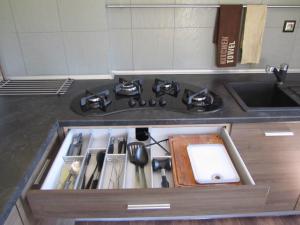 a kitchen counter with a stove and a sink at Konrado in Dziwnów