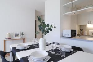 A kitchen or kitchenette at Modern apartment close to Martigny train station