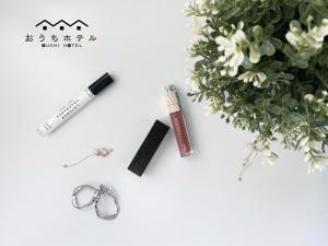 a set of earrings and a mascara and a bouquet of flowers at OUCHI HOTEL Otemachi in Hiroshima
