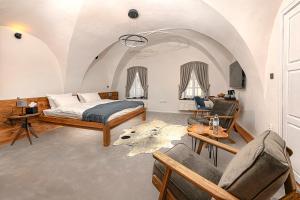 a bedroom with a bed and a living room at Boutique hotel & spa DOMA u nás - entry AquaCity free in Poprad