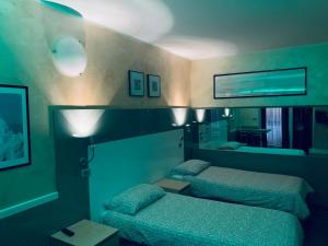 Postel nebo postele na pokoji v ubytování Hotel Malpensafiera