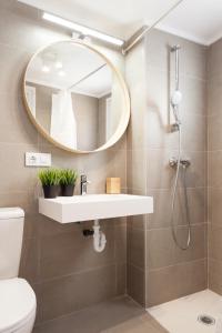 a bathroom with a sink and a mirror at L'Havanera Boutique Home in Palamós