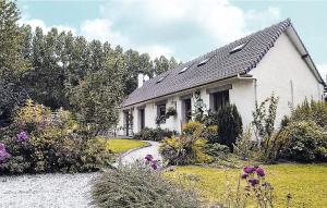 a white house with a garden in front of it at la roseraie in Caumont