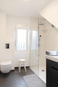 a bathroom with a shower and a toilet and a stool at Casa de la Abuela en el Camino de Santiago a Finiesterre in Negreira