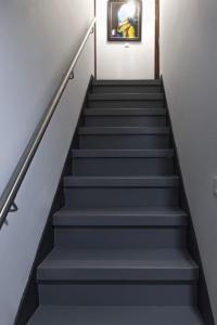 a stairway with grey stairs with a picture on the wall at Casa de la Abuela en el Camino de Santiago a Finiesterre in Negreira