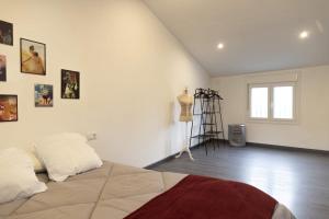 a white room with a bed and some pictures on the wall at Casa de la Abuela en el Camino de Santiago a Finiesterre in Negreira