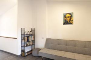 a living room with a couch and a book shelf at Casa de la Abuela en el Camino de Santiago a Finiesterre in Negreira