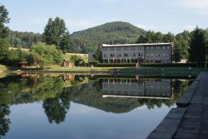 a building with its reflection in a lake at Vlčí důl Bludov in Bludov